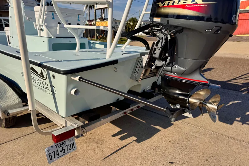 Slide: The Image of Waterman Wildwater 23 boat, 2023 model, on trailer with outboard motor, Texas license plate. - 6