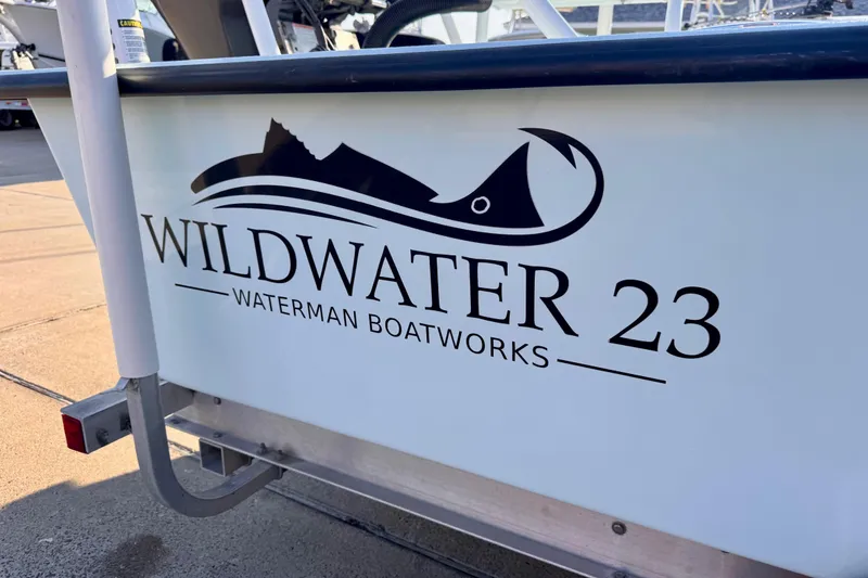 Slide: The Image of Waterman Wildwater 23 boat logo, 2023 model, featuring sleek design and branding. - 7