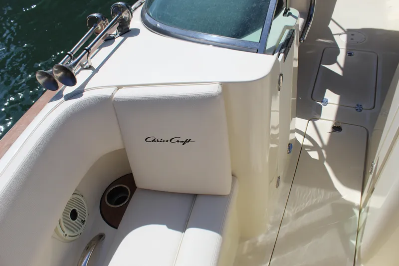 Slide: The Image of 2022 Chris-Craft Launch 27 boat interior with beige seating and logo detail. - 14