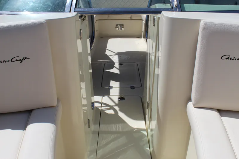 Slide: The Image of 2022 Chris-Craft Launch 27 interior with white seating and open walkway. - 17