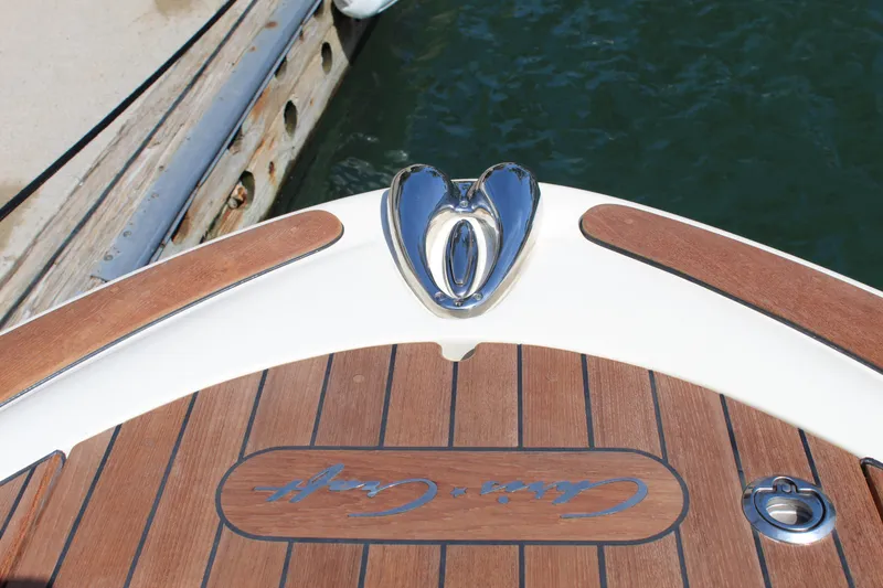 Slide: The Image of 2022 Chris-Craft Launch 27 boat deck with wood finish and chrome details. - 19