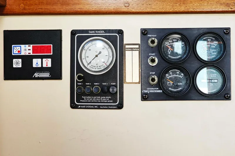 Slide: The Image of Control panel of a 1996 Nordic Tug 26 with gauges and switches. - 13