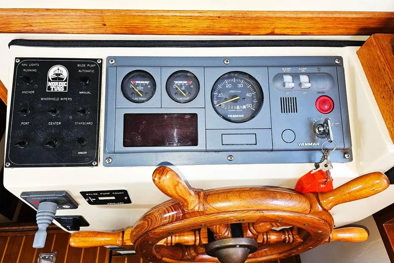 Slide: The Image of Control panel of a 1996 Nordic Tug 26 with wooden steering wheel and Yanmar gauges. - 14