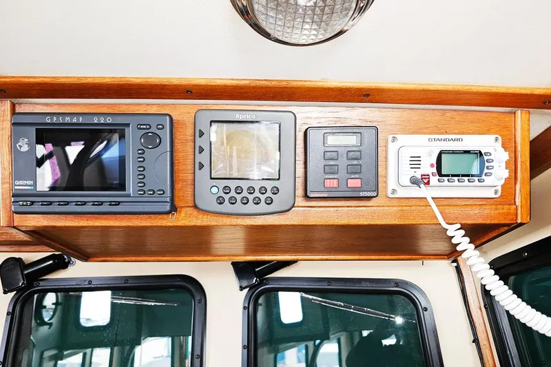 Slide: The Image of Navigation equipment on a 1996 Nordic Tug 26 boat dashboard. - 15