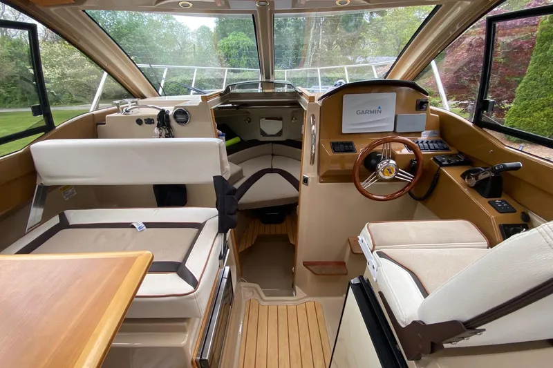 Slide: The Image of Interior of 2016 Cutwater C-24 boat with steering wheel and seating area. - 10