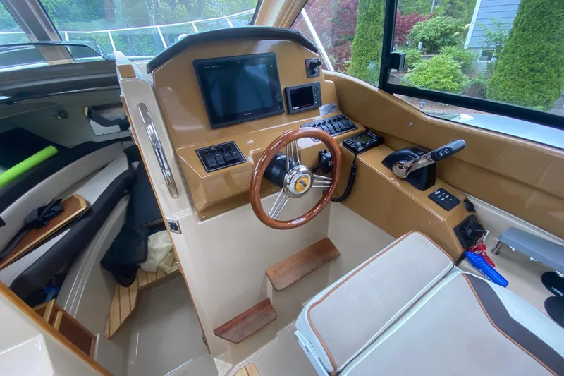 Slide: The Image of Interior of 2016 Cutwater C-24 boat cockpit with steering wheel and control panel. - 11