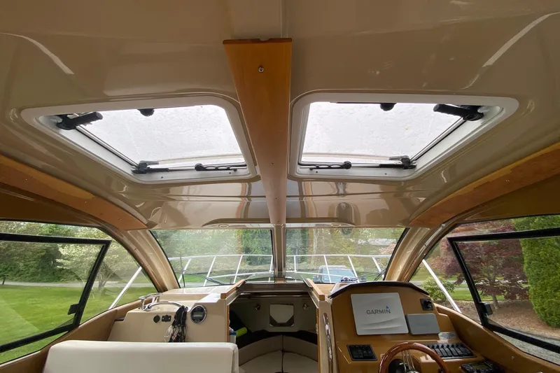 Slide: The Image of Interior view of 2016 Cutwater C-24 boat cockpit with skylights and navigation equipment. - 12