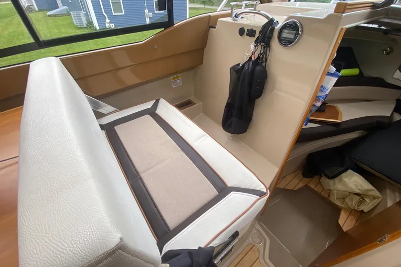 Slide: The Image of Interior of a 2016 Cutwater C-24 boat, featuring seating and storage areas. - 13