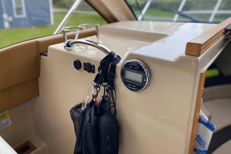 Slide: The Image of Interior of a 2016 Cutwater C-24 boat with control panel and hanging accessories. - 14