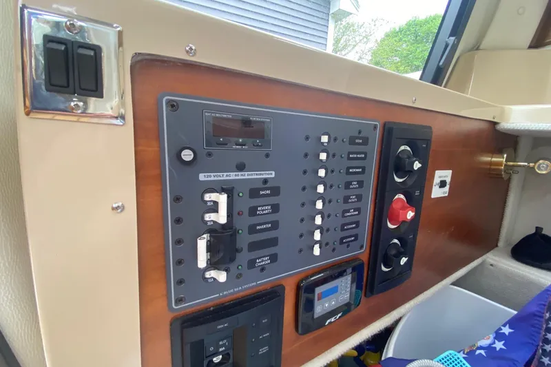 Slide: The Image of Control panel of a 2016 Cutwater C-24 boat, featuring switches and gauges. - 16
