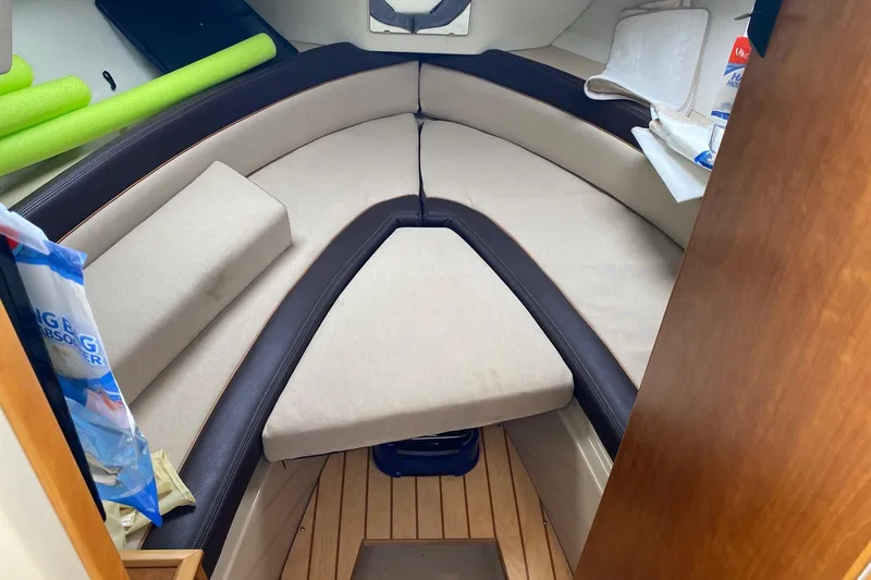 Slide: The Image of Interior cabin of a 2016 Cutwater C-24 boat with beige cushions and wooden flooring. - 18
