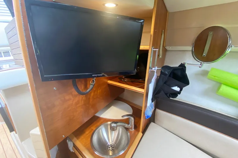 Slide: The Image of 2016 Cutwater C-24 interior with TV, sink, and mirror. - 19