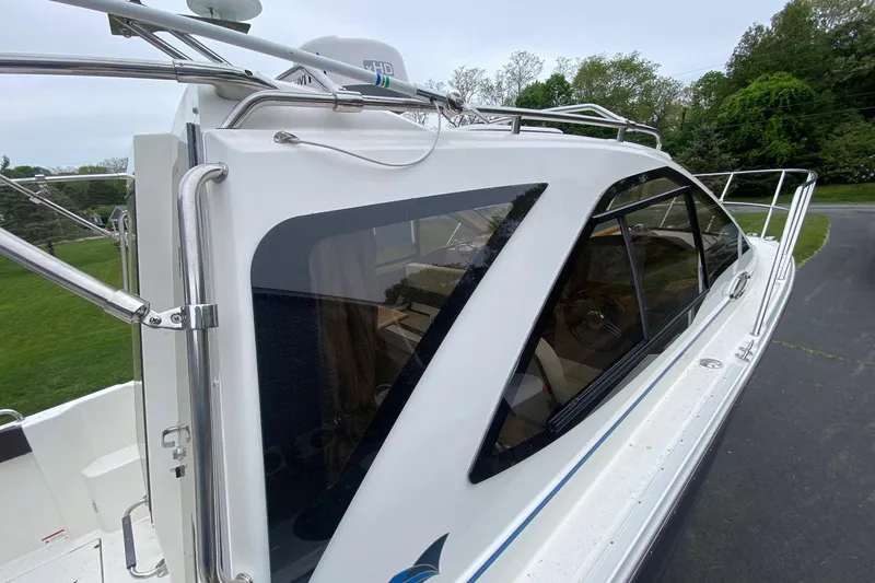 Slide: The Image of 2016 Cutwater C-24 boat with sleek design and tinted windows, docked on a driveway. - 26