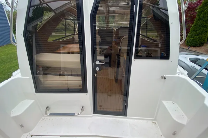 Slide: The Image of 2016 Cutwater C-24 boat with glass doors and interior seating visible. - 27