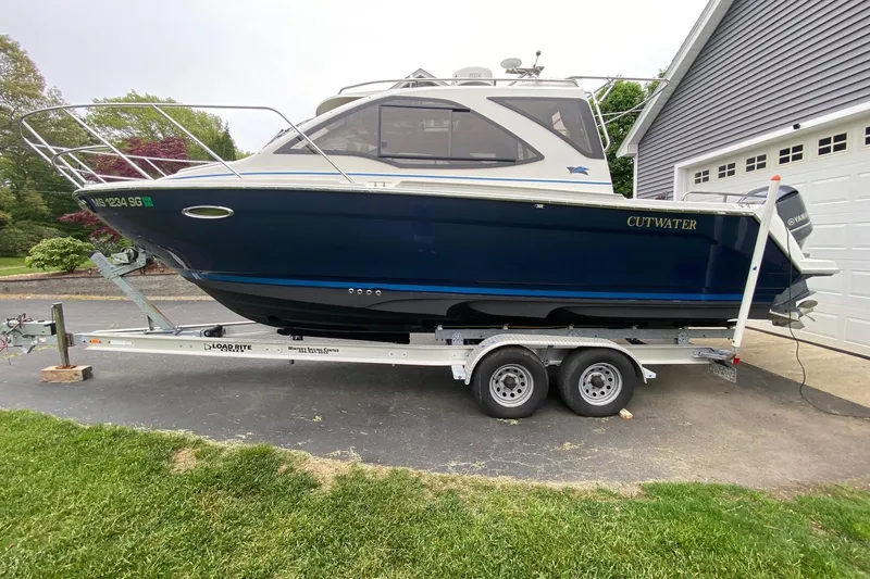 Slide: The Image of 2016 Cutwater C-24 boat on trailer, parked beside a garage. - 7