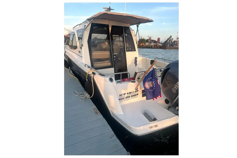 Slide: The Image of 2016 Cutwater C-24 boat docked, featuring a Yamaha outboard motor and nautical flag. - 9
