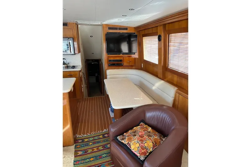 Slide: The Image of Interior of 2001 Hatteras 55 Convertible yacht with cozy seating and modern amenities. - 11
