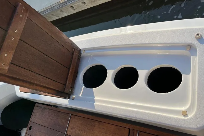 Slide: The Image of Open wooden hatch on 2001 Hatteras 55 Convertible boat, revealing circular compartments. - 13