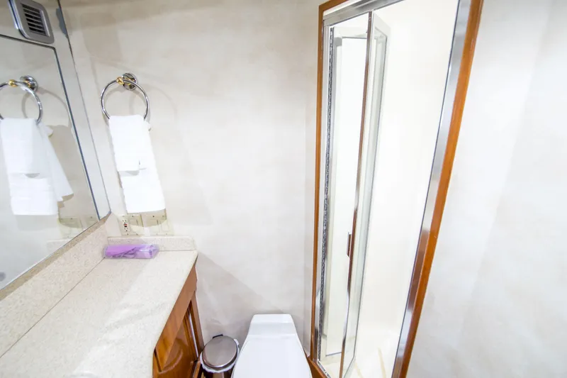 Slide: The Image of Bathroom interior of 2001 Hatteras 55 Convertible yacht, featuring shower and vanity. - 35