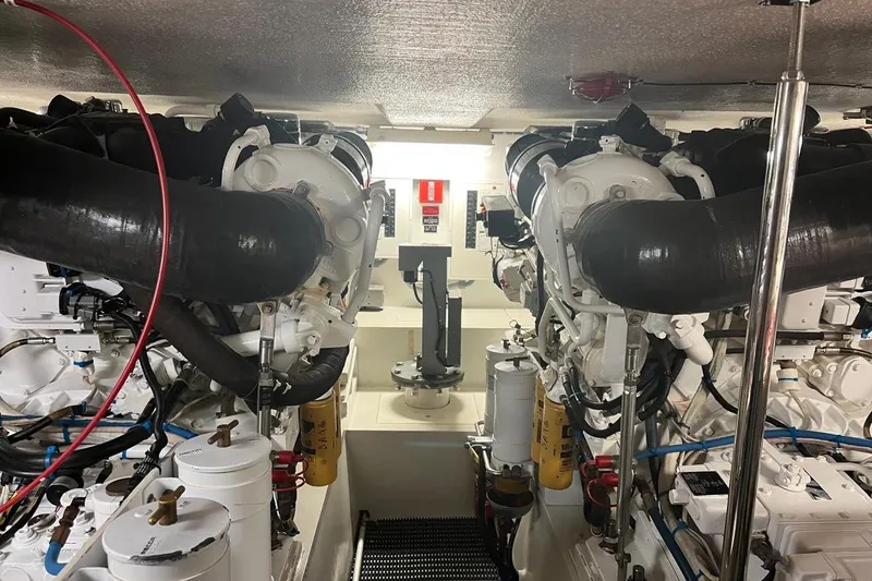 Slide: The Image of Engine room of 2001 Hatteras 55 Convertible yacht, showcasing dual engines and mechanical components. - 15