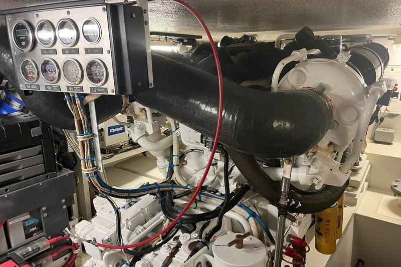 Slide: The Image of Engine room of a 2001 Hatteras 55 Convertible yacht, showcasing gauges and machinery. - 17