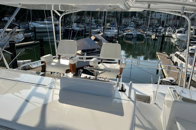 Slide: The Image of 2001 Hatteras 55 Convertible yacht helm with marina view. - 5