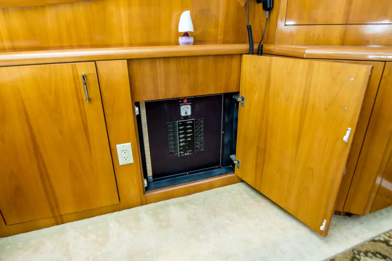 Slide: The Image of Electrical panel inside a 2001 Hatteras 55 Convertible yacht's wooden cabinet. - 21
