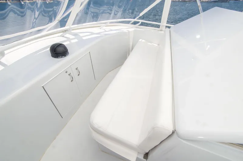 Slide: The Image of 2001 Hatteras 55 Convertible yacht deck with white seating and storage cabinet. - 16