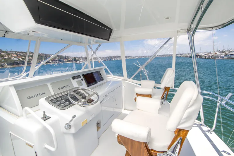 Slide: The Image of Helm of 2001 Hatteras 55 Convertible yacht with Garmin navigation, overlooking marina. - 11