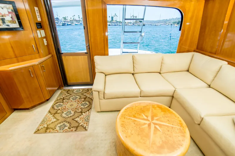 Slide: The Image of Luxurious interior of 2001 Hatteras 55 Convertible yacht with beige sofa and ocean view. - 19