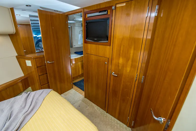 Slide: The Image of Interior of 2001 Hatteras 55 Convertible yacht with wood cabinetry and built-in TV. - 37