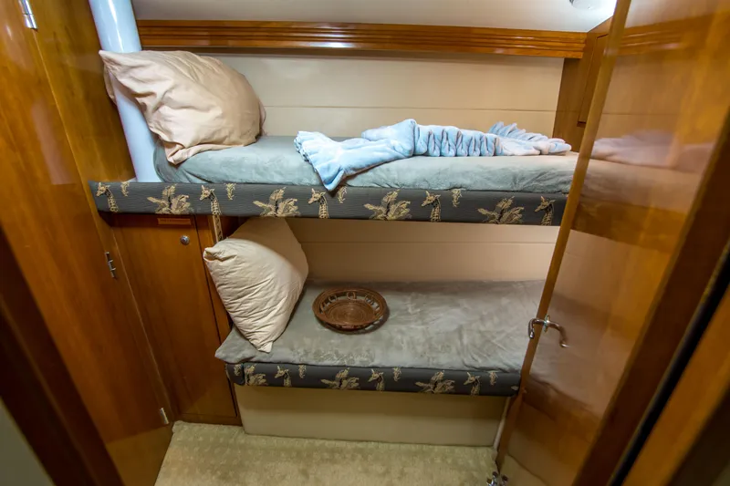 Slide: The Image of Bunk beds in 2001 Hatteras 55 Convertible yacht cabin with wooden finish. - 36