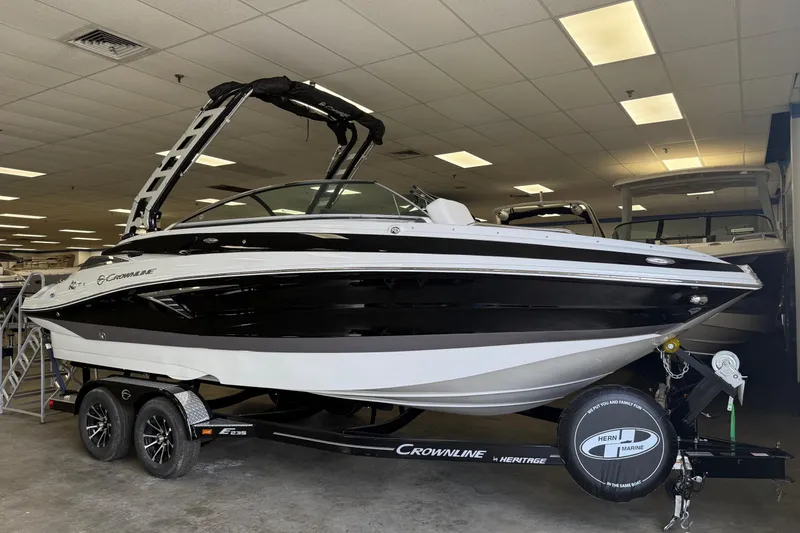 The Image of 2025 Crownline Eclipse E235 boat on trailer in showroom. - 1