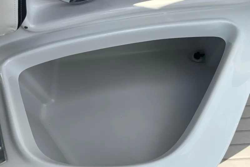 Slide: The Image of Storage compartment in 2025 Crownline Eclipse E235 boat, featuring sleek white interior design. - 13