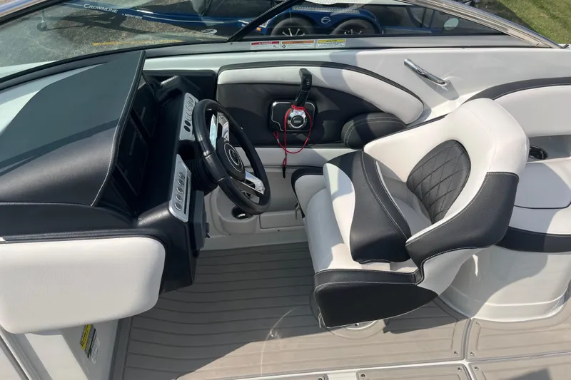 Slide: The Image of Interior of 2025 Crownline Eclipse E235 boat with sleek black and white seating. - 18