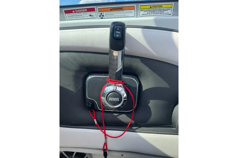 Slide: The Image of Throttle control of 2025 Crownline Eclipse E235 boat with Volvo Penta branding and safety warnings. - 20