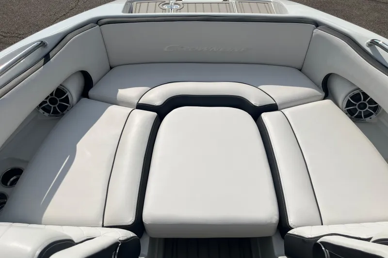 Slide: The Image of 2025 Crownline Eclipse E235 boat interior with plush seating and integrated speakers. - 24