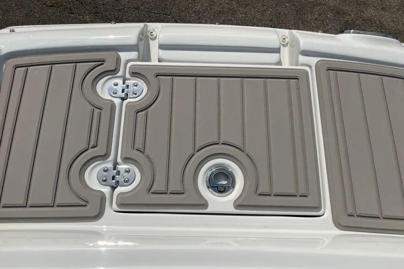Slide: The Image of 2025 Crownline Eclipse E235 boat deck with textured panels and latch. - 25