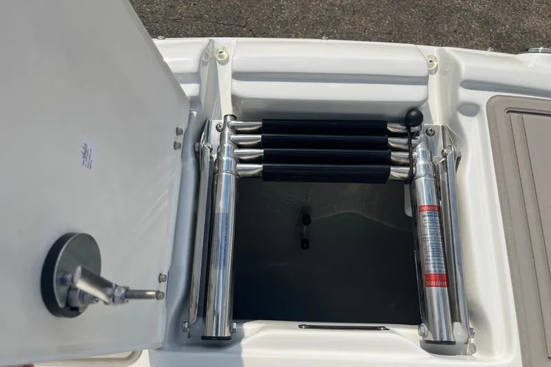 Slide: The Image of 2025 Crownline Eclipse E235 boat compartment with hydraulic lift and storage space. - 26