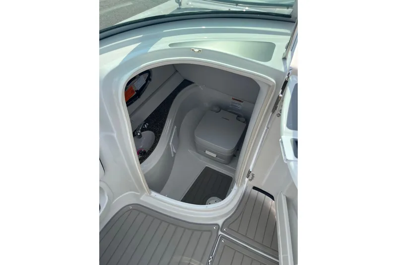 Slide: The Image of Interior view of 2025 Crownline Eclipse E235 boat cabin with compact toilet. - 27
