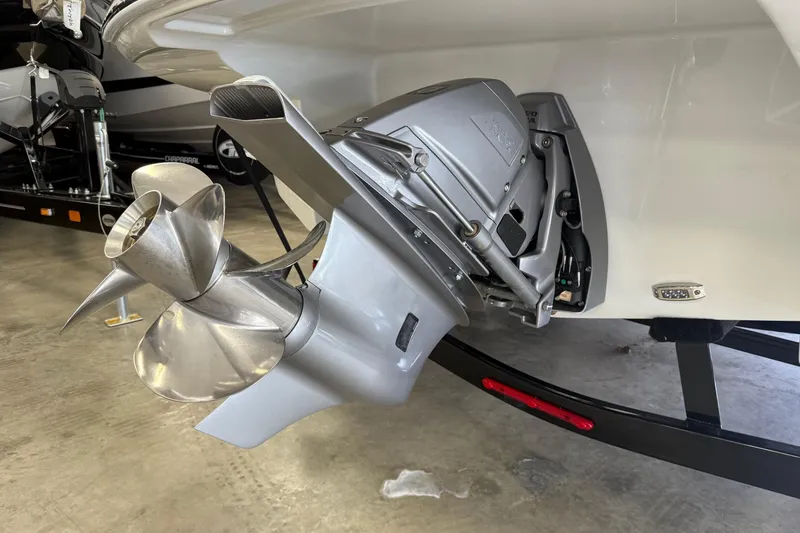 Slide: The Image of 2025 Crownline Eclipse E235 boat propeller and outdrive in showroom. - 6