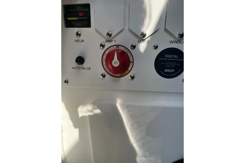 Slide: The Image of Control panel of 2025 Crownline Eclipse E235 boat with switches and digital relay. - 9