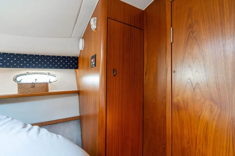 Slide: The Image of Interior of 1998 Tiara Yachts 3500 Express with wooden cabinetry and small window. - 21