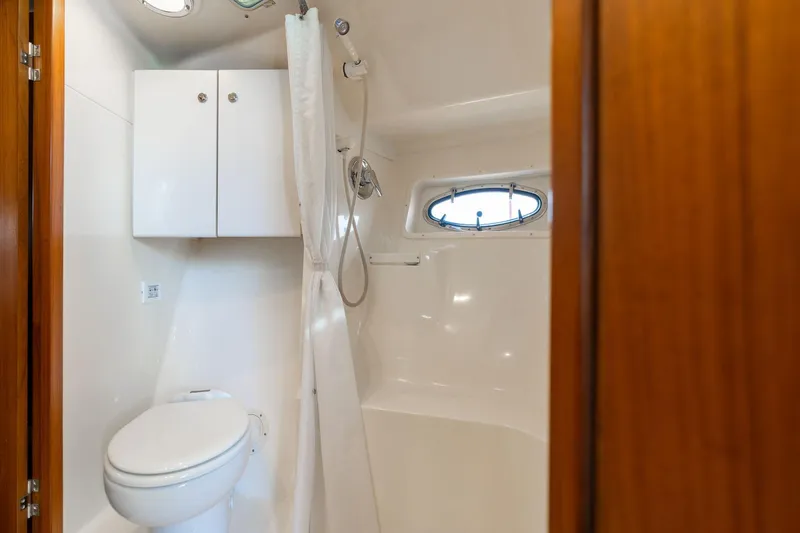 Slide: The Image of Bathroom interior of 1998 Tiara Yachts 3500 Express with shower and porthole window. - 22