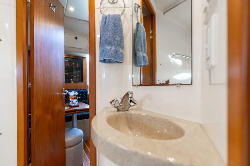 Slide: The Image of Bathroom interior of 1998 Tiara Yachts 3500 Express with sink and mirror. - 24