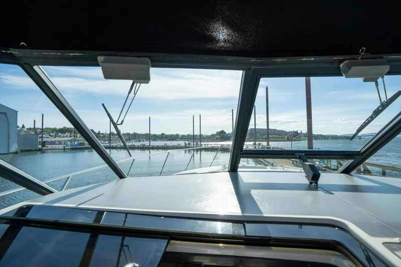 Slide: The Image of View from the helm of a 1998 Tiara Yachts 3500 Express, overlooking a marina. - 28