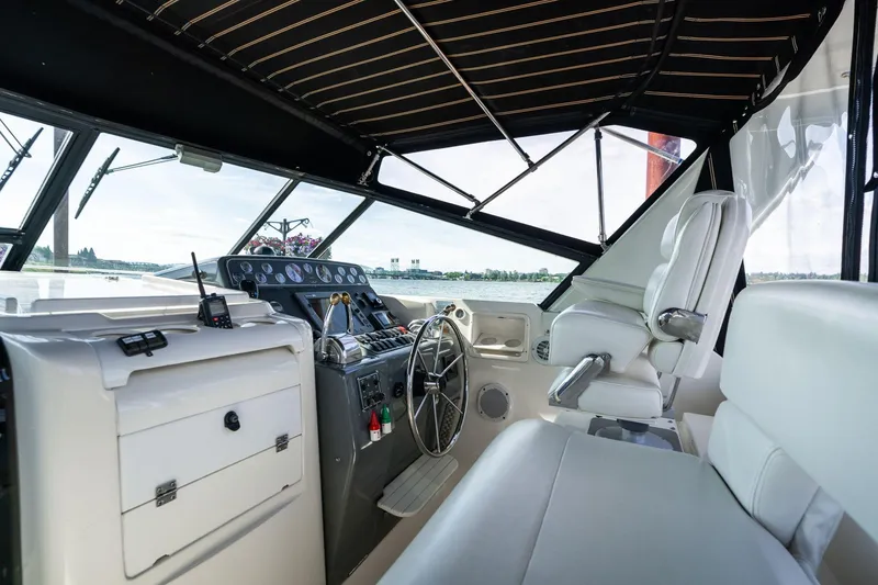 Slide: The Image of Interior cockpit of a 1998 Tiara Yachts 3500 Express, featuring helm and seating. - 29
