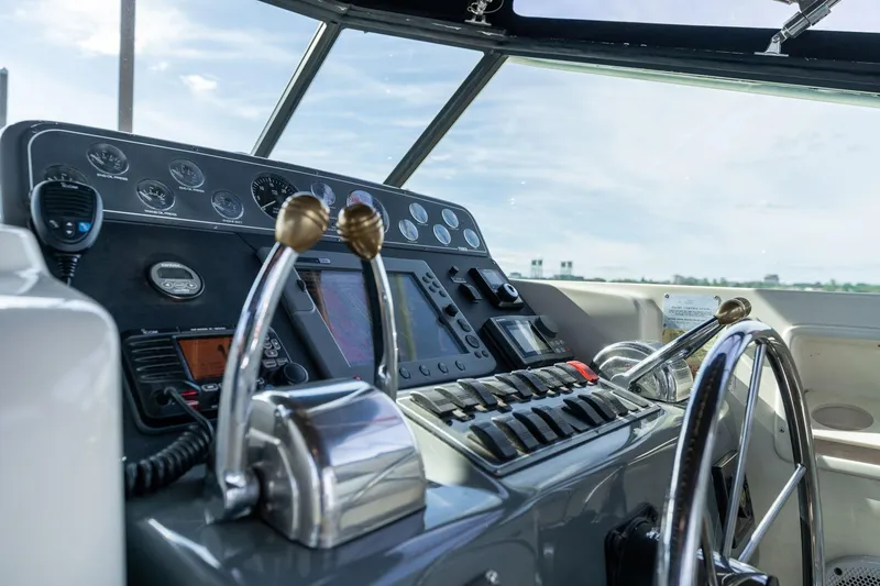 Slide: The Image of Cockpit of 1998 Tiara Yachts 3500 Express with navigation controls and steering wheel. - 31