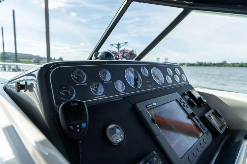 Slide: The Image of Dashboard of a 1998 Tiara Yachts 3500 Express with gauges and navigation equipment. - 32