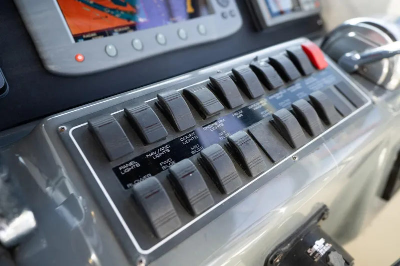 Slide: The Image of Control panel of a 1998 Tiara Yachts 3500 Express boat with switches and navigation display. - 36